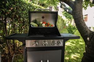 a grill with a bowl of vegetables on it at Apartments Medora in Rovinj