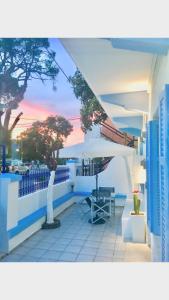 a patio with a table and a white umbrella at Kyano House in Limenas