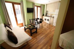 a living room with a couch and a table and a kitchen at Alojamientos Toletvm in Toledo +14 photos