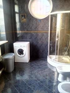 a bathroom with a washing machine and a toilet at Дом на берегу Черного Моря in Zatoka