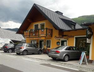a group of cars parked in front of a building at Gasthof-Pension Stieber in Kleinsölk
