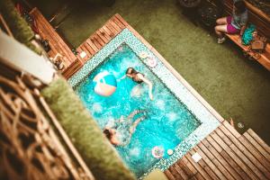 an overhead view of two people swimming in a swimming pool at The Clock Hostel & Suites in Cartagena de Indias