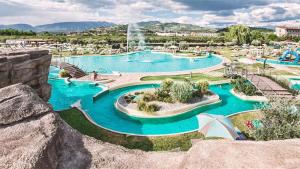 a large pool with blue water in a resort at Casa Vacanze Francesca in Bussolengo