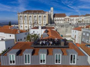 a group of people sitting on the roof of a building at Sapientia Boutique Hotel in Coimbra