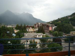 a view from a balcony of a town with mountains at Mar Mar Appartaments in Briançon