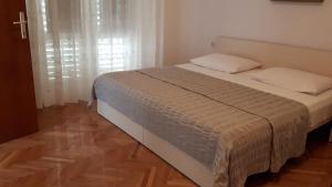 Postel nebo postele na pokoji v ubytování Apartments Kekica