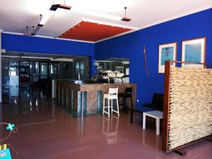 a room with a blue wall and a bar at HOTEL LAGO in Villanueva de Arosa