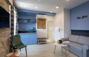 a living room with blue walls and a couch and a table at Apartments and Rooms Villa Naida in Dubrovnik