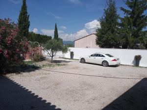 a white car parked next to a white wall at Studio Valreas Avec Piscine in Valréas