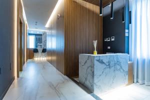 a lobby with a marble counter and a hallway with stools at Concept Terrace Hotel in Rome
