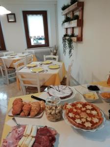 a table with many different types of food on it at B&B La casa di Loretta in Paderno