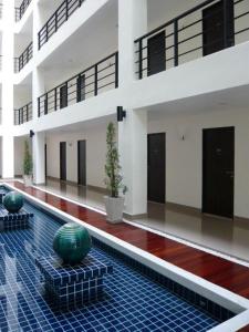 a large building with a pool in the middle at The Atrium Ratchada 13 in Bangkok