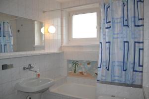 a bathroom with a sink and a shower curtain at Bursztynowa Wyspa in Gdańsk