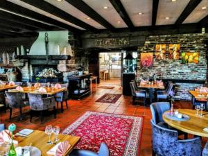 a restaurant with tables and chairs and a brick wall at Burg Wassenberg in Wassenberg