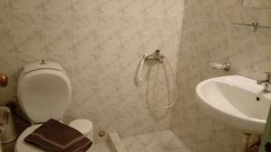 a bathroom with a toilet and a sink at Kadmos in Loutra Edipsou +55 photos