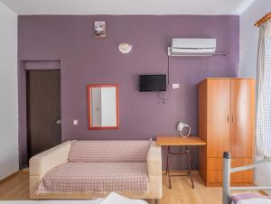 a bedroom with a bed and a purple wall at Efsali Hotel Kaleiçi in Antalya