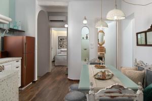 a kitchen with a table and a dining room at Casa Pietra Lindos Luxury Traditional House in Líndos