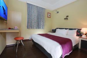 Postel nebo postele na pokoji v ubytování King Town Hotel