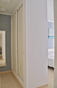 a bedroom with white cabinets and a bed at Home Sweet Home with Ocean View in Costa Calma +19 photos