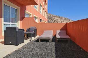 a group of benches sitting next to a building at Home Sweet Home with Ocean View in Costa Calma