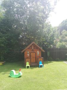 a small childs play house in a yard at Pensiunea Vladut in Bran