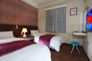 Postel nebo postele na pokoji v ubytování King Town Hotel