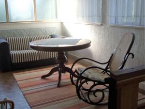 a table and a chair in a room with a couch at Villa KIM in Kraljevica