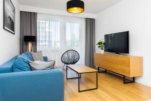 TV a/nebo společenská místnost v ubytování FARO Apartamenty Bliżej Morza