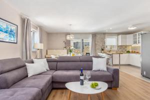 a living room with a couch and a table at Apartment Niki in Opatija