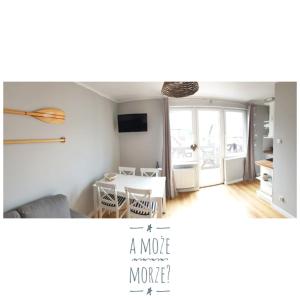 a living room with a table and a dining room at A może morze? in Sztutowo