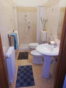 a bathroom with a sink and a toilet and a shower at Guglielmo room's B&B in Catania