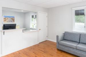 a living room with a couch and a tv at Ocean Park Inn Cape Cod in Eastham