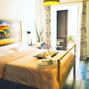 a bedroom with a large bed with a yellow ceiling at Domus Alma in Naples