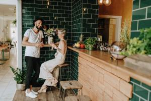 a man and a woman sitting at a bar at Huber's Hotel in Baden-Baden