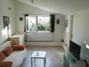 a living room with a couch and a tv at Olive grove in Vodice