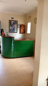a green counter in the middle of a room at Kanberra Hotel in Lira