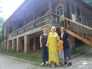 three women and a child standing in front of a building at Victoria in Bagdatʼi