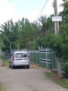 a car parked in a parking lot next to a fence at Victoria in Bagdatʼi +34 photos