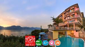 a hotel with a view of the water and mountains at Hotel Eden in Brenzone sul Garda