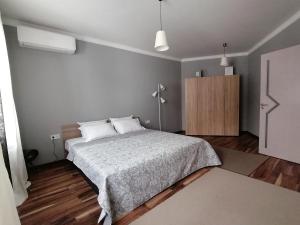 a bedroom with a bed and a wooden floor at Casa Lavenda in Plovdiv
