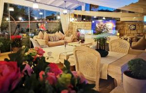 a room with a table and chairs and a couch at Salbakos Herakleia Hotel in Alacati