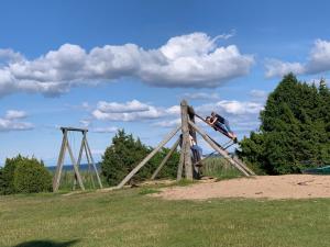 a couple of people sitting on top of a play structure at Ottenson Saaremaa apartment in Salme