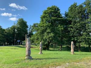 a group of statues sitting in a field at Ottenson Saaremaa apartment in Salme