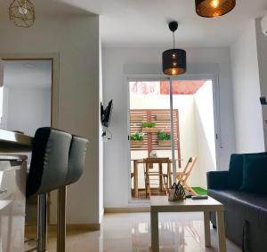a living room with a blue couch and a table at Castle Apartment in Alicante