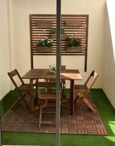 a wooden table and chairs on a patio at Castle Apartment in Alicante