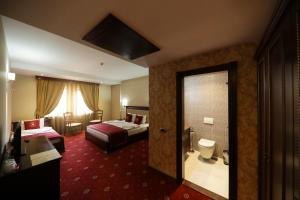 Tempat tidur dalam kamar di Hotel Kacinari