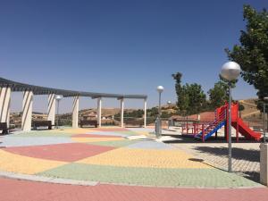 a playground with a slide in a park at CASA RURAL LA CIJA in Maello