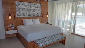 
A bed or beds in a room at Azura Beach Resort - All Inclusive - Adults Only
