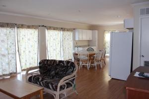 a kitchen and living room with a table and a refrigerator at Blue Haven Apartments in Ocean City +11 photos