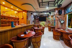 a restaurant with wooden tables and a bar at Quinta Bella Huatulco in Santa Cruz Huatulco